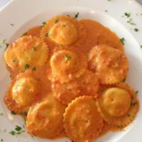 Ravioli · Cheese-filled pasta served in marinara or Bolognese sauce.