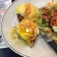 Crab Cake Benedict · Fresh lump crab cakes topped with poached eggs & hollandaise served with fresh garden salad