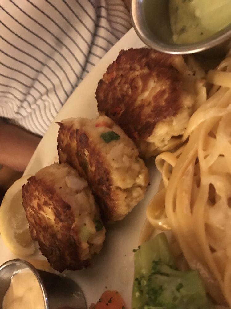 Jumbo Lump Crab Cakes · Pan-seared, loaded with jumbo lump crab meat and a blend of seasonings. Served with house-made avocado cream and Joe's mustard sauce.