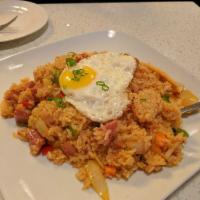 Kimchi Fried Rice · Fried rice with kimchi, ham, bacon and vegetables topped with a fried egg.