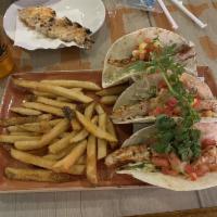 Fish Tacos · Crisply fried in LandShark batter wrapped in a grilled flour tortilla and layered with grill...