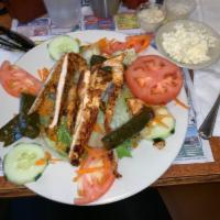 Greek Salad · Chopped lettuce, feta cheese, stuffed grape leaves, olives, onions, tomatoes and sliced cucu...