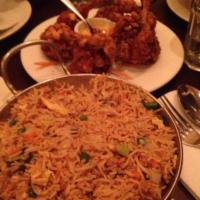 Chicken Biryani · Tender chicken cooked with basmati rice and flavored with saffron.