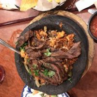Molcajete · Steak and chicken fajita strips, bell peppers, onions, and chorizo. All covered with Jack ch...