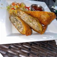 Jerk Chicken Egg Rolls · Served with sweet chili sauce. Spicy.