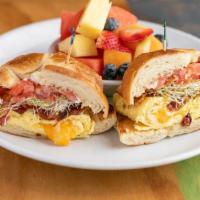 Croissant Breakfast · 2 scrambled eggs, mixed cheddar cheese, tomatoes, choice of real or mock bacon, sprouts and ...