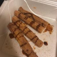 Churros · Thick fritter sticks coated with sugar and cinnamon.