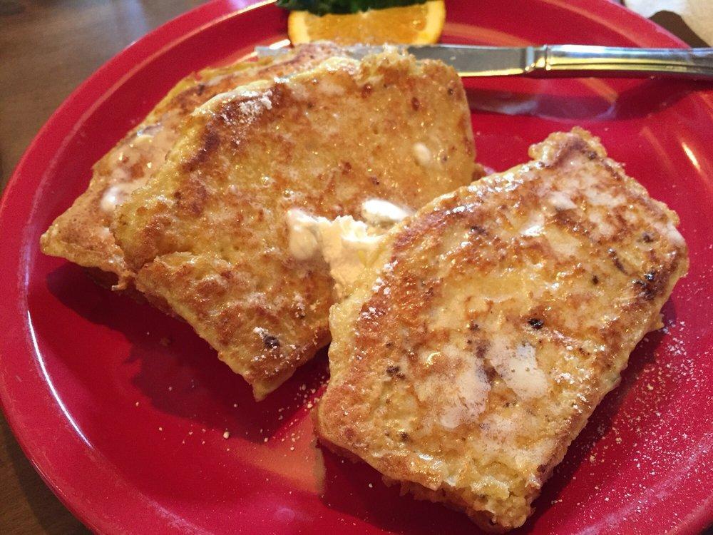 Cornbread French Toast · 3 slices of our cornbread are battered and grilled to a golden brown then topped with whipped butter and powdered sugar. 

