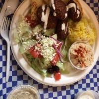 Falafel Plate · 4 falafel patties served with rice, Greek salad, hummus, babaganush, pita bread and side of ...