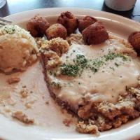 Country Fried Steak · The Classic done right! Topped with homemade country gravy and served with mashed potatoes a...