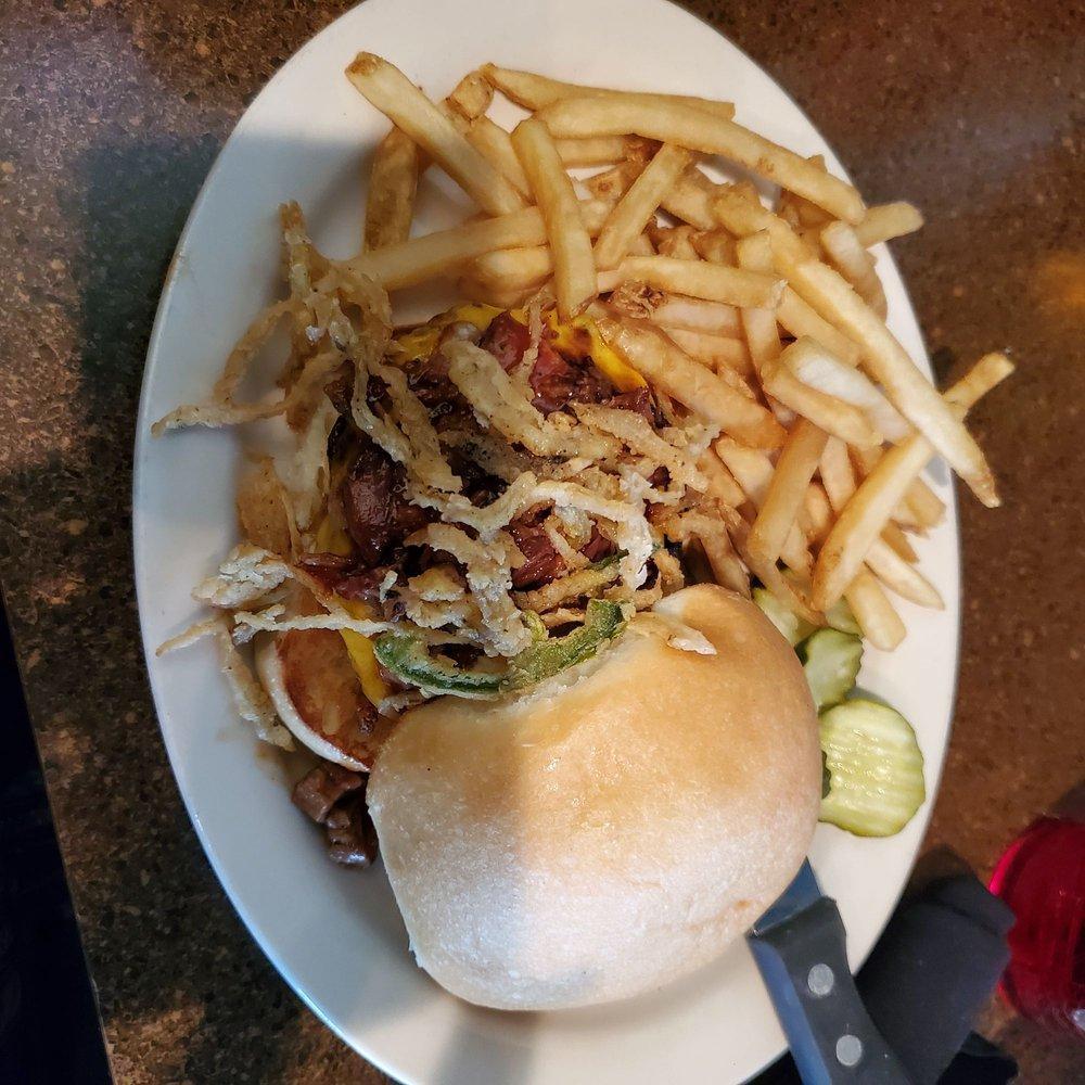 Brisket Burger · Your choice of patty topped with chopped brisket, cheddar cheese and fried jalapeño onion strings with pickles on the side. Served with fries.