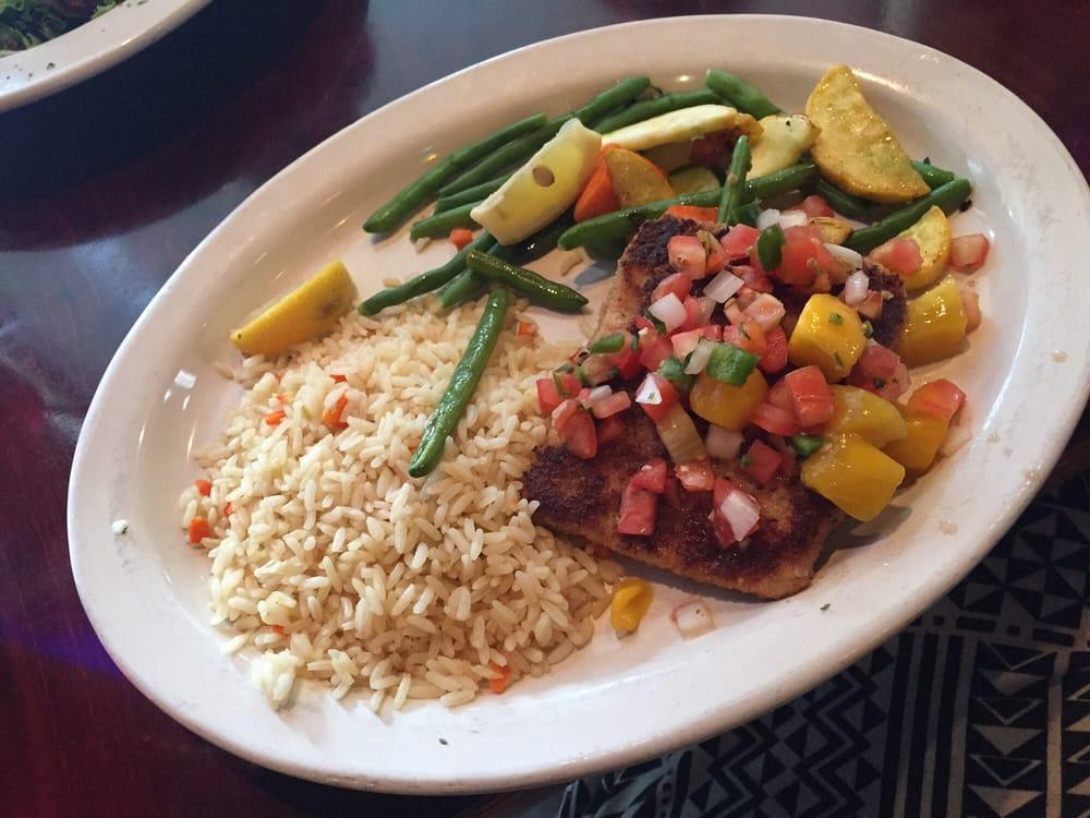 Mango Salmon · Herb crumb-crusted salmon filet topped with mango pico de gallo and served with rice and veggie medley.