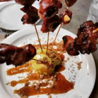 Bacon Lollipops · Brown sugar dipped smoked bacon wrapped over a slow roasted skewered apple. A fun treat to s...