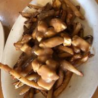 Poutine · From the backwoods of Quebec, Canada, white cheddar cheese curds over hand-cut fries, smothe...