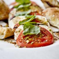 Insalata Caprese · Sliced fresh mozzarella, sliced tomatoes, salt, pepper, pistachios, basil, balsamic glaze, o...