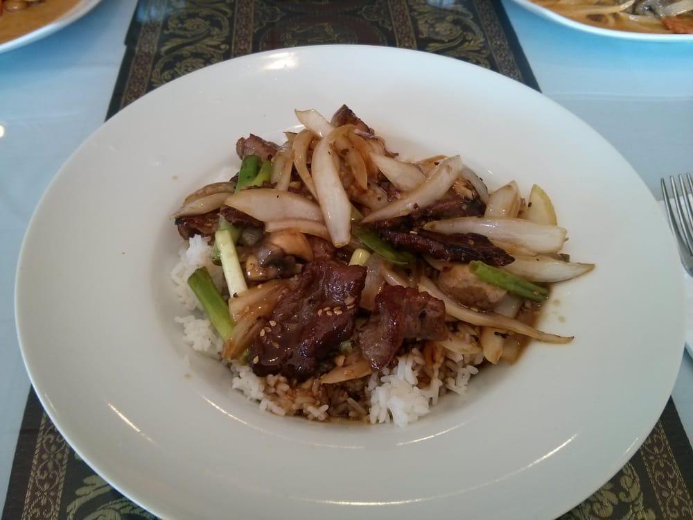 Bangkok Beef · Stir-fried marinated beef with onions, mushroom, scallions, and toasted sesame. Served over jasmine rice. 