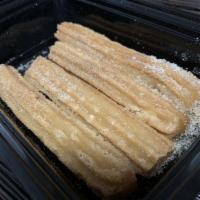 Churros · Fried churros stuffed caramel & cinnamon sugar.