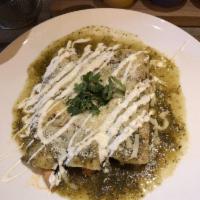 Chicken Enchiladas · corn tortilla, chicken stew, salsa verde, cheese, sour cream, rice & beans
