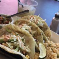 Fish Tacos · Tilapia served in flour tortillas with rice and charro beans.