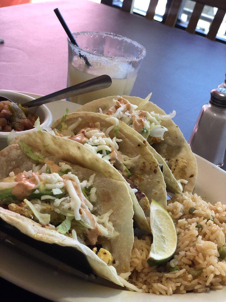 Fish Tacos · Tilapia served in flour tortillas with rice and charro beans.