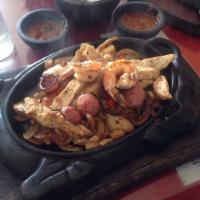 Fajitas Nortenas · Steak or Chicken Fajitas with grilled sausage, onions, bell pepper, cheese, guacamole and so...