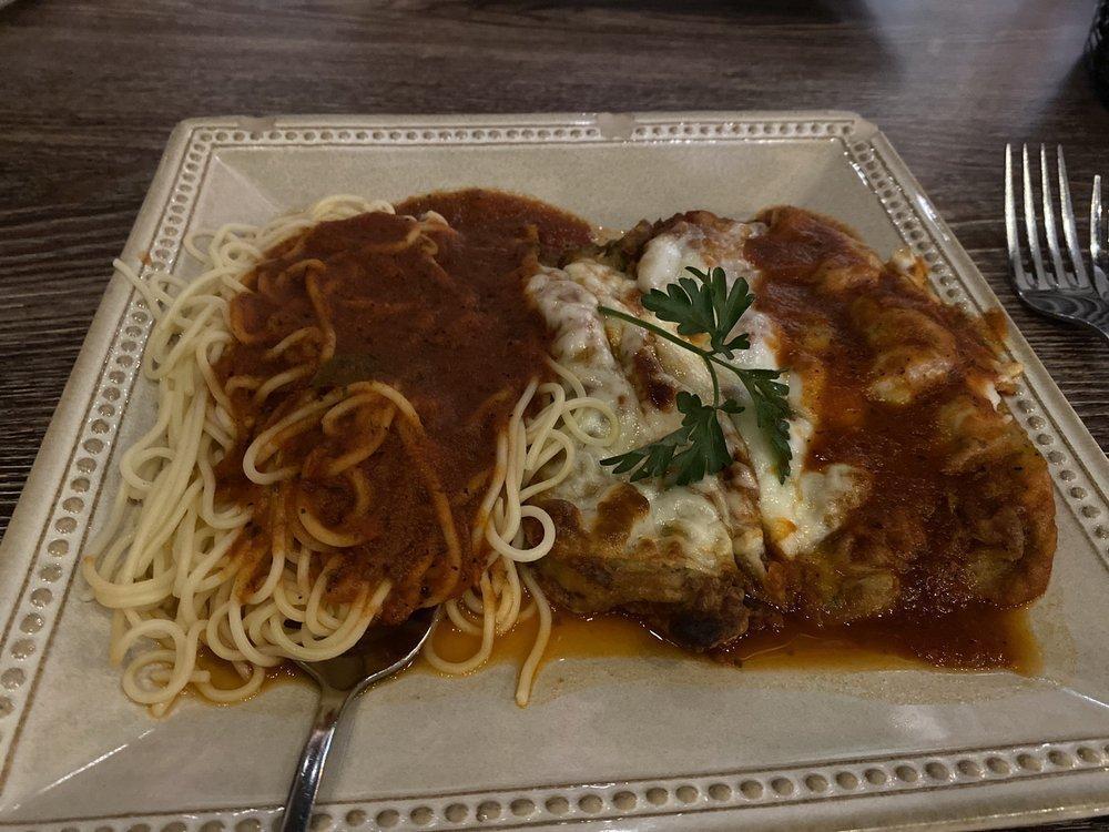 Parmigiana · Breaded chicken (or veal) topped with mozzarella cheese, and marinara, over spaghetti.