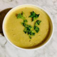 Grandma Zarifa's Lentil Soup · Vegan. Gluten-free. Red lentils simmered with red bell peppers, onions and spices. Served wi...