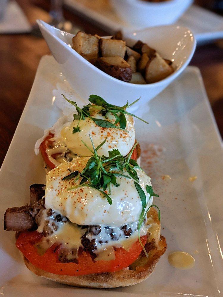 Grove Eggs Benedict · Pork belly, tomatoes, poached egg, English muffins topped with hollandaise, grove potatoes.