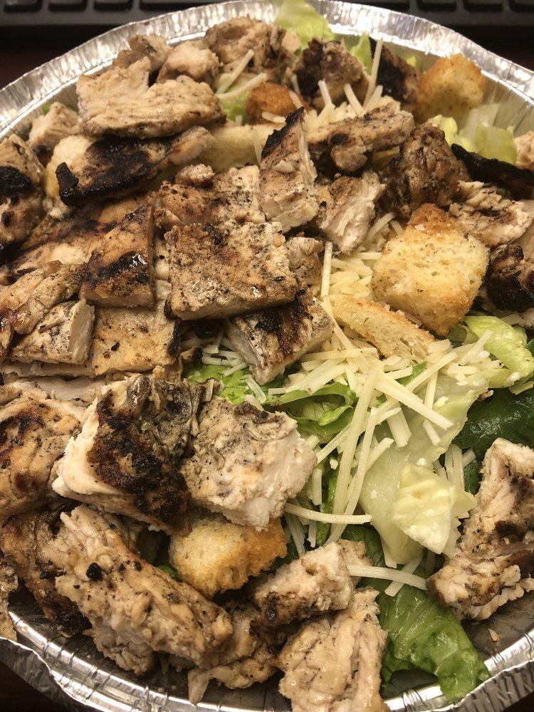 Chicken Caesar Salad · Hearts of romaine, chopped marinated grilled chicken breast, Parmesan, and garlic croutons with Caesar dressing.