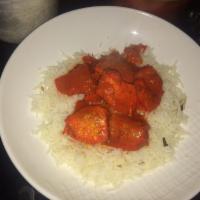 Chicken Vindaloo · Classic chicken curry cooked in hot and tangy sauce with potato and pepper chine. Served wit...