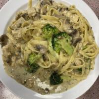 Chicken Alfredo · Fettuccine and mushrooms in white sauce. Served with green salad and garlic bread.