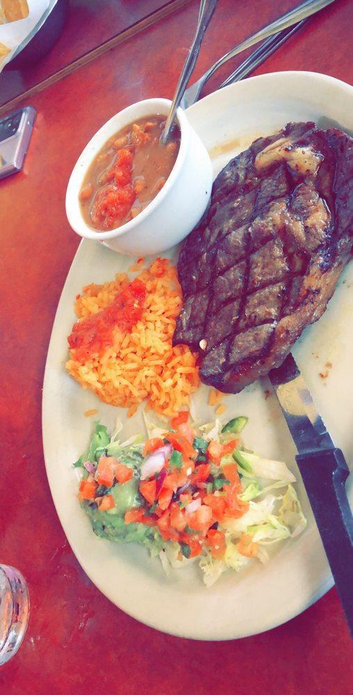 Carne Asada · Marinated grilled rib-eye steak topped with green scallions. Served with rice, pico de gallo, and guacamole.