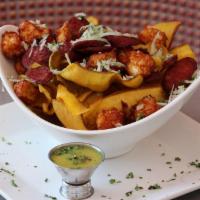 Mariquitas · Plantain chips with mojo sauce.
