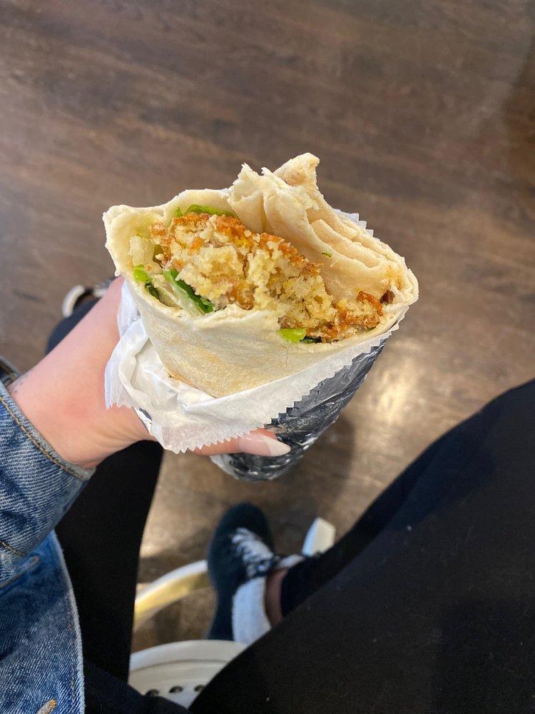 Falafel Wrap · Falafel (fried chickpeas). Served with hot sauce, hummus, lettuce, tomato, onions, hot peppers, pickle, tabouleh, tahini and a yogurt-cucumber sauce.