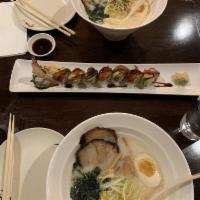 Dragon Roll · Shrimp tempura cucumber roll with eel, avocado, tobiko and eel sauce on top.