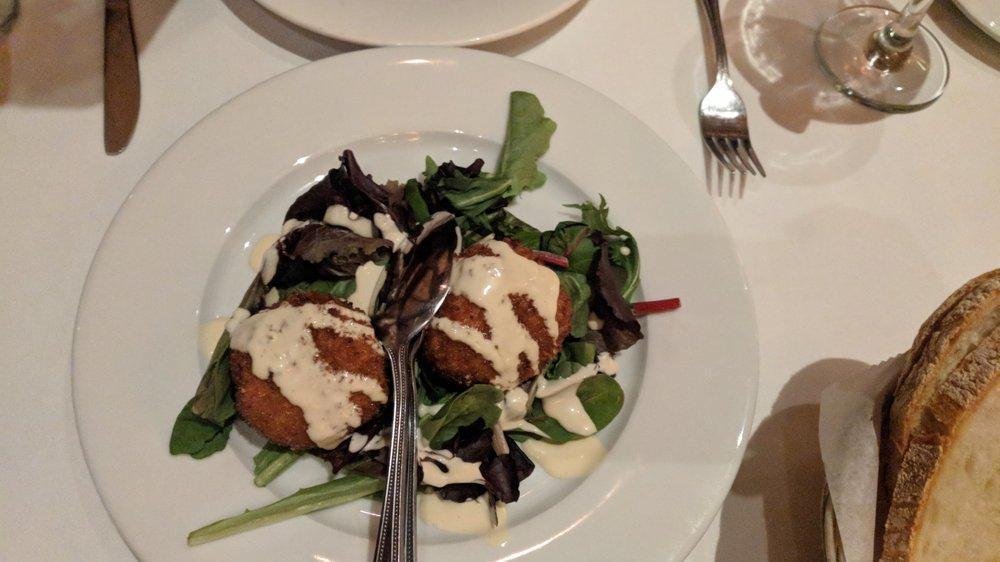 Crab Cake · Pan-seared crab cakes over a bed of lettuce.
