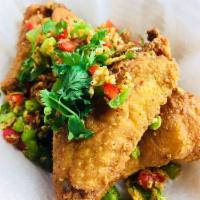 6 Garlic Wings · Seasoned chicken wins tossed with bell peppers, fried garlic, jalapeno peppers and green oni...