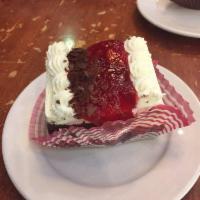 Black Forest · Cherries and whipped cream between 2 layers of chocolate cake. Topped with more whipped crea...
