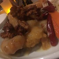 Vanilla Prawns · Jumbo fried prawns tossed in a honey cream sauce and topped with candied walnuts with pickle...