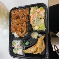 Chicken Bento Box · Served with steamed rice, California roll (4pcs), dumplings (3pcs) and garden salad.