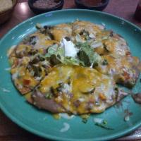 Mexican Pizza · Deep-fried flour tortilla topped with beans and cheese, choice of chicken or beef, tomato, o...