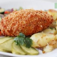 Chicken Kiev · Hand breaded tenderized chicken breast fillet stuffed with herb butter, served with garlic r...