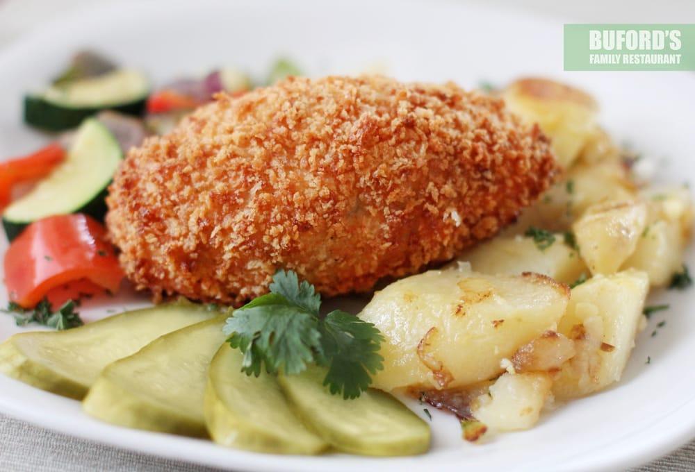Chicken Kiev · Hand breaded tenderized chicken breast fillet stuffed with herb butter, served with garlic roasted potatoes and stir-fried vegetables.