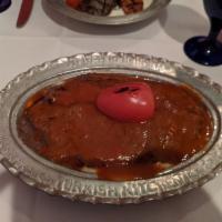 Iskender Kebab · Vertically grilled lamb sliced very thin served with garlic yogurt and tomato sauce over pit...