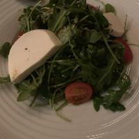 Arugula Salad · Baby arugula, cherry tomatoes, mozzarella with extra virgin olive oil and balsamic reduction.