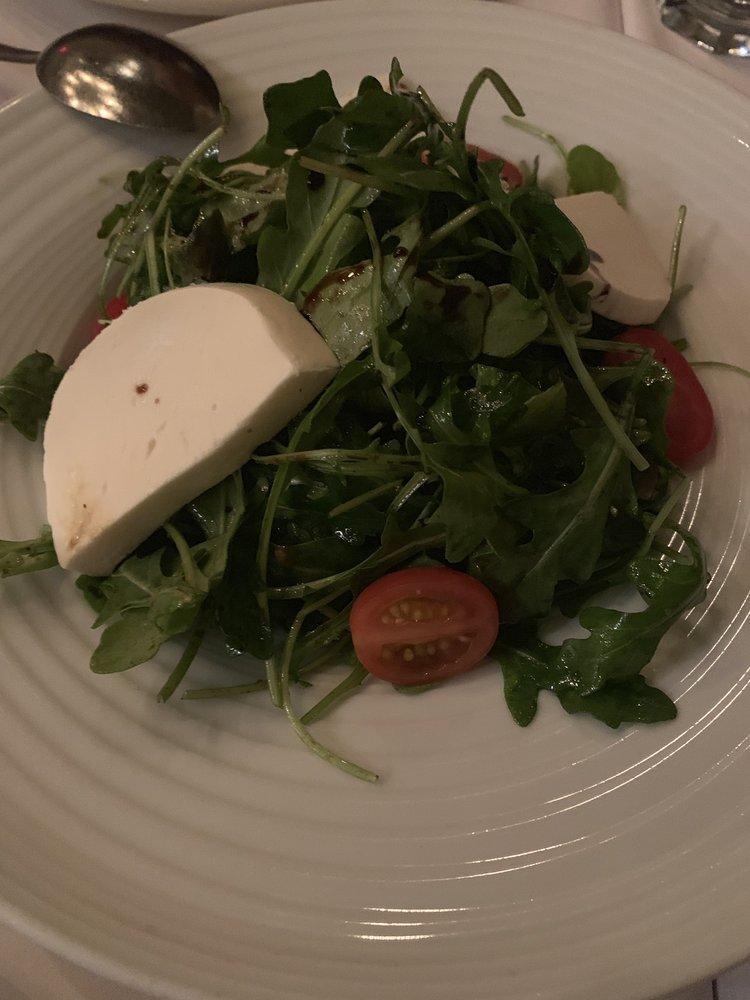 Arugula Salad · Baby arugula, cherry tomatoes, mozzarella with extra virgin olive oil and balsamic reduction.