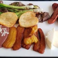 Churrasco Chapin · Grilled scallions over 1 lb. of beef served with beans, chorizo, cheese, fried banana and cr...