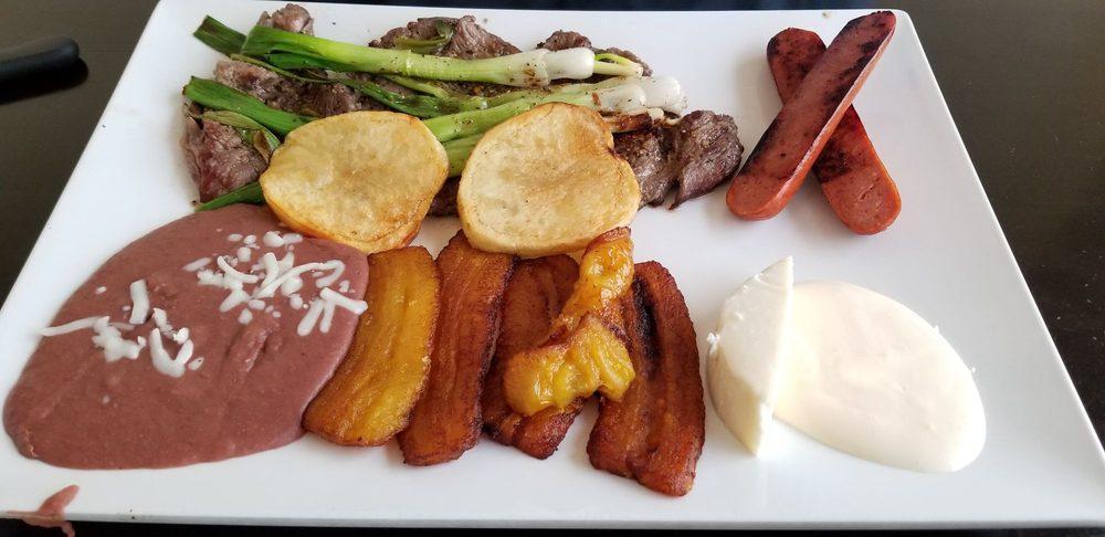 Churrasco Chapin · Grilled scallions over 1 lb. of beef served with beans, chorizo, cheese, fried banana and crema.
