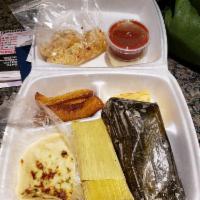 Plato Tipico · Sampler plate with 1 pupusa, 1 chicken tamal, 1 sweet corn tamal, fried cassava roots and fr...