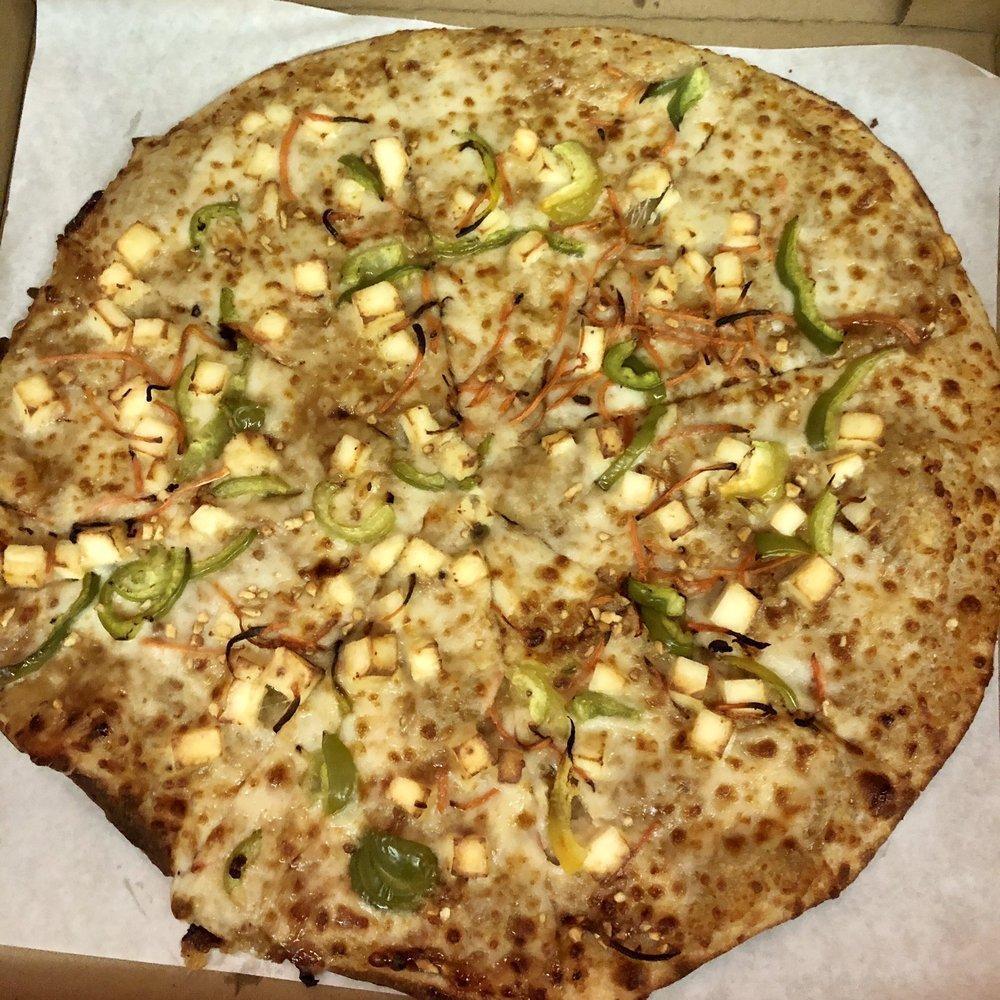 Thai Peanut Curry Pizza · Chicken or paneer with mozzarella, bell peppers, carrots, cilantro and peanuts on peanut curry.